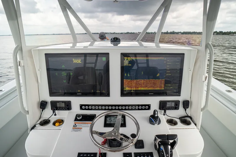 Slide: The Image of 2023 Contender 44 ST boat dashboard with advanced navigation screens and controls. - 27