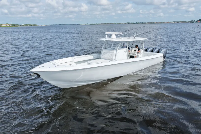 The Image of 2023 Contender 44 ST boat cruising on open water under a cloudy sky. - 0