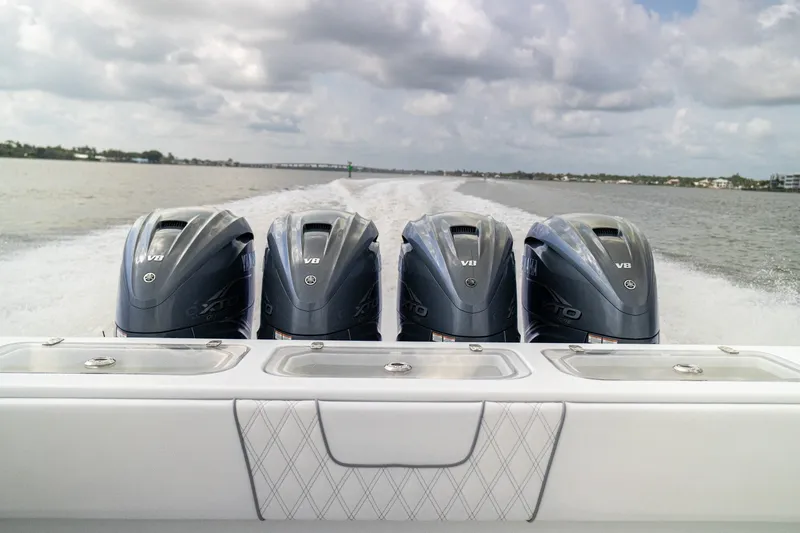 Slide: The Image of 2023 Contender 44 ST boat with four powerful V8 outboard engines on open water. - 26