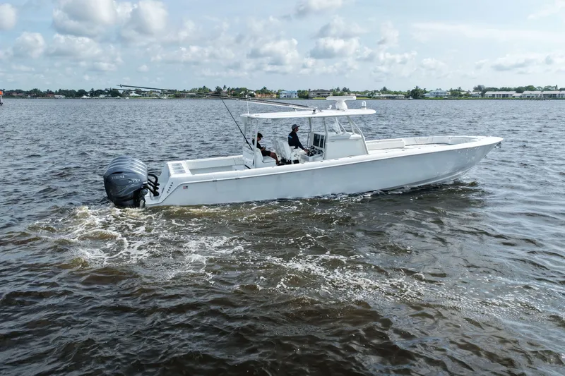 Slide: The Image of 2023 Contender 44 ST boat cruising on open water under a cloudy sky. - 23