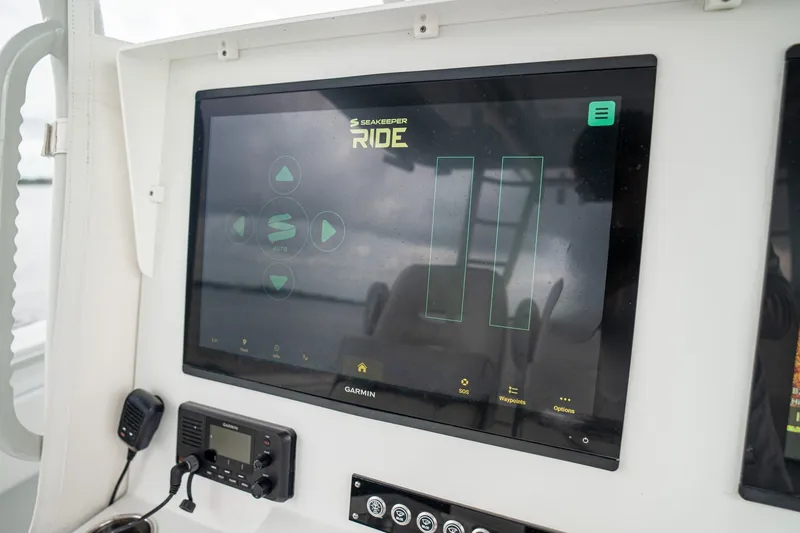Slide: The Image of Control panel of 2023 Contender 44 ST boat featuring Seakeeper Ride system. - 32
