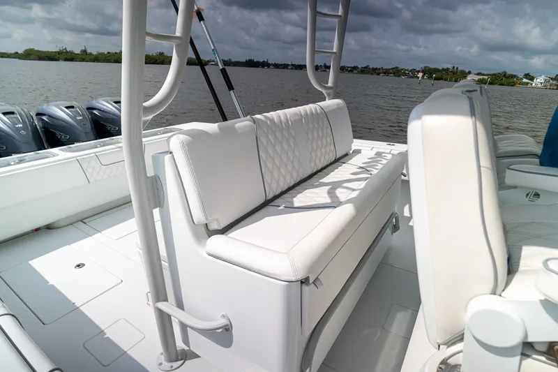 Slide: The Image of 2023 Contender 44 ST boat interior with white seating and multiple outboard engines. - 20