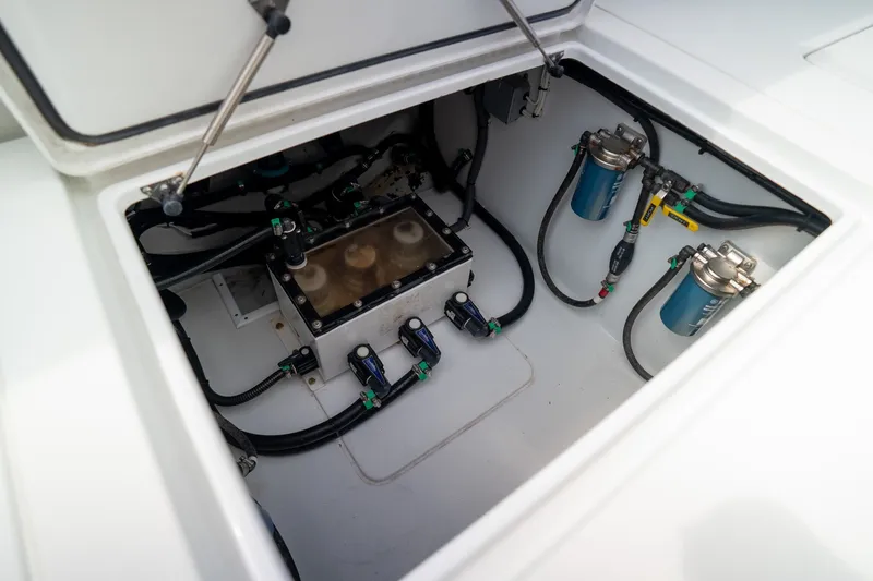 Slide: The Image of 2023 Contender 44 ST boat compartment with fuel filters and wiring. - 28
