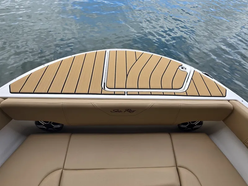 Slide: The Image of The image shows the stern of a Sea Ray SDX 270 Surf boat with sleek upholstery and wood details. - 25