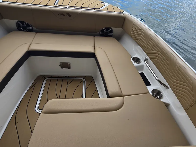 Slide: The Image of The image shows the seating area of a Sea Ray SDX 270 Surf boat with beige upholstery. - 23