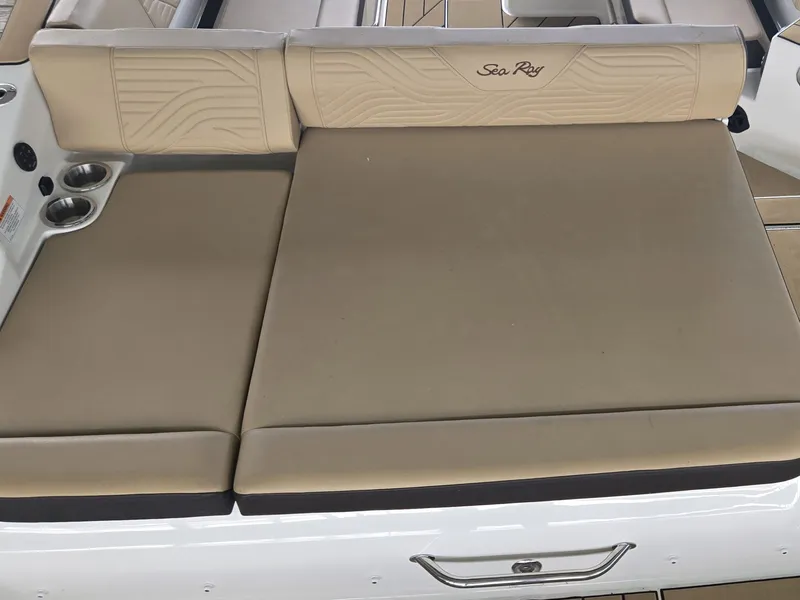 Slide: The Image of The image shows a beige lounging area on a Sea Ray SDX 270 Surf boat. - 8