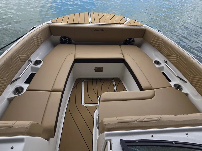 Slide: The Image of The image shows the spacious bow area of a Sea Ray SDX 270 Surf with beige upholstery. - 20