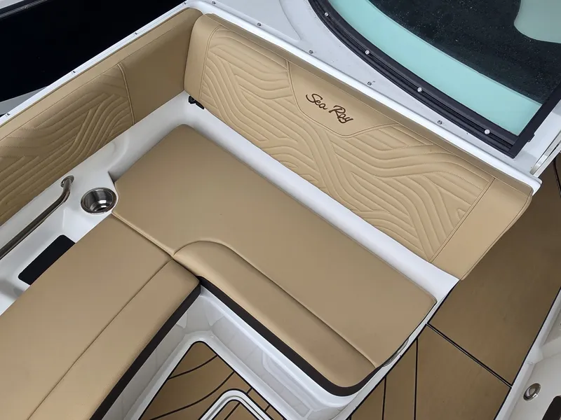 Slide: The Image of The 2027 Sea Ray SDX 270 Surf features elegant beige upholstery with an embroidered logo. - 24