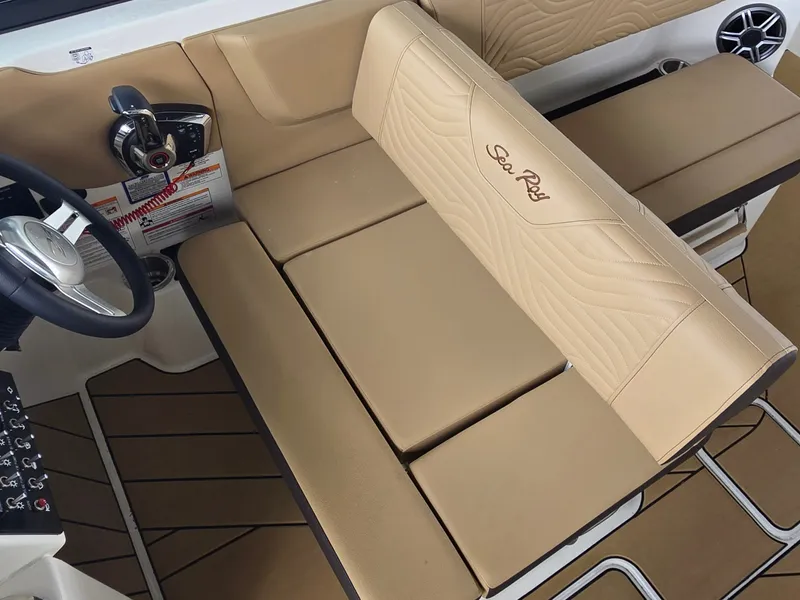 Slide: The Image of The image shows the interior of a Sea Ray SDX 270 Surf with beige upholstery and a steering wheel. - 15