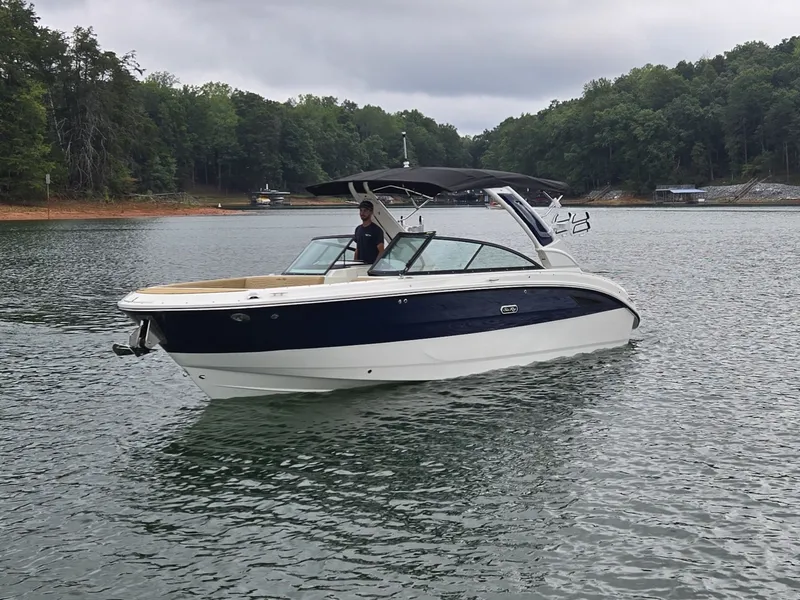 Slide: The Image of A 2027 Sea Ray SDX 270 Surf on a calm lake with a wooded shoreline. - 31