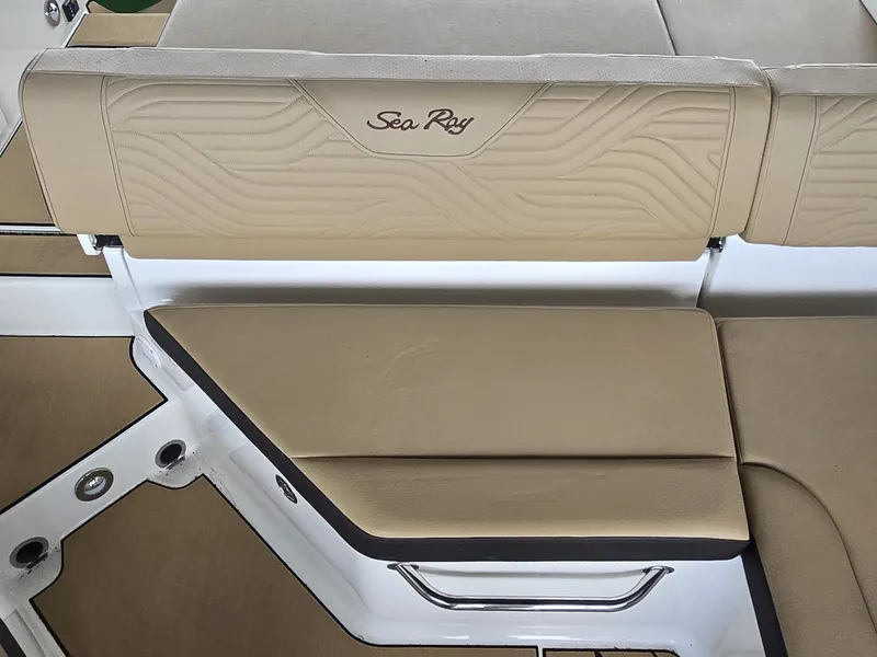 Slide: The Image of The 2027 Sea Ray SDX 270 Surf features beige upholstery with an embroidered logo. - 9