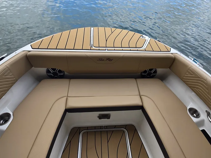 Slide: The Image of The image shows the bow area of a Sea Ray SDX 270 Surf boat with beige upholstery. - 22