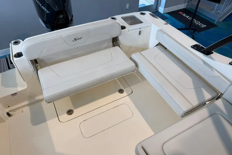 Slide: The Image of 2026 Scout 240 Dorado boat interior with white seating and Mercury engine. - 17