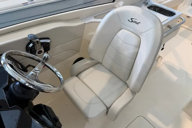 Slide: The Image of 2026 Scout 240 Dorado boat interior with steering wheel and luxurious seating. - 9
