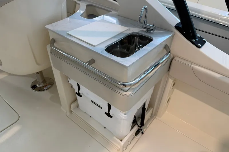 Slide: The Image of 2026 Scout 240 Dorado boat interior with sink and storage area. - 15