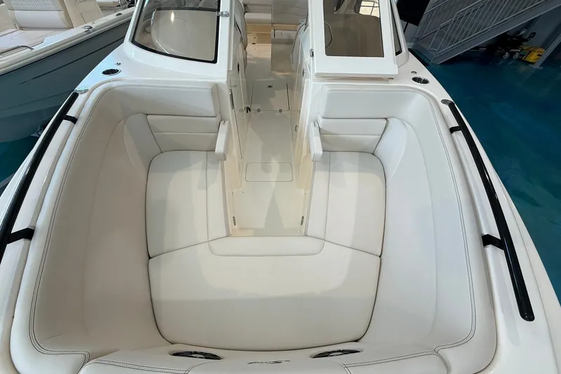 Slide: The Image of 2026 Scout 240 Dorado boat interior with white cushioned seating and sleek design. - 4