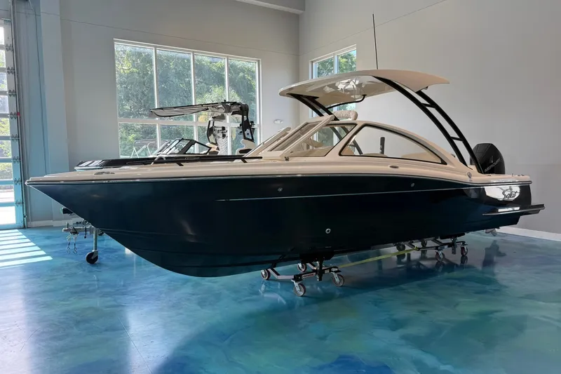 Slide: The Image of 2026 Scout 240 Dorado boat displayed indoors on a polished blue floor. - 1