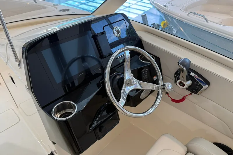 Slide: The Image of Steering console of 2026 Scout 240 Dorado boat with modern controls and display. - 10