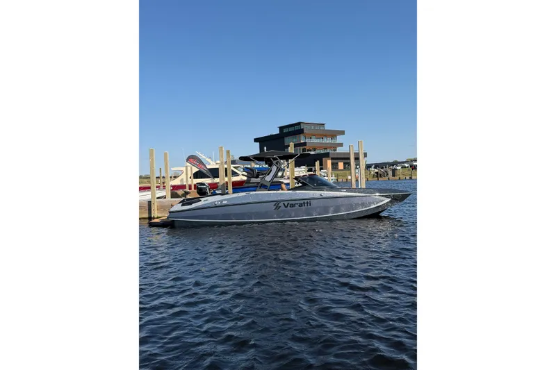Slide: The Image of 2025 Varatti Z2373 boat docked on a sunny day, modern building in background. - 10