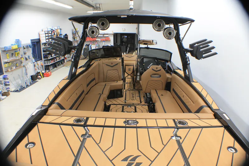 Slide: The Image of Varatti Z2373 2025 boat interior with tan seating and advanced audio system in a showroom. - 3