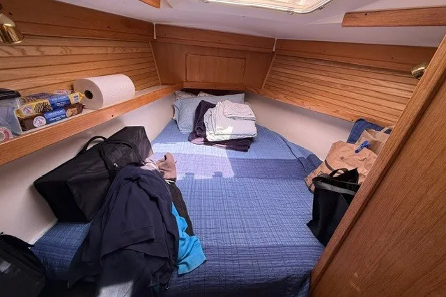 Slide: The Image of Cozy cabin interior of a 2005 Catalina 400 sailboat with a neatly made bed. - 48