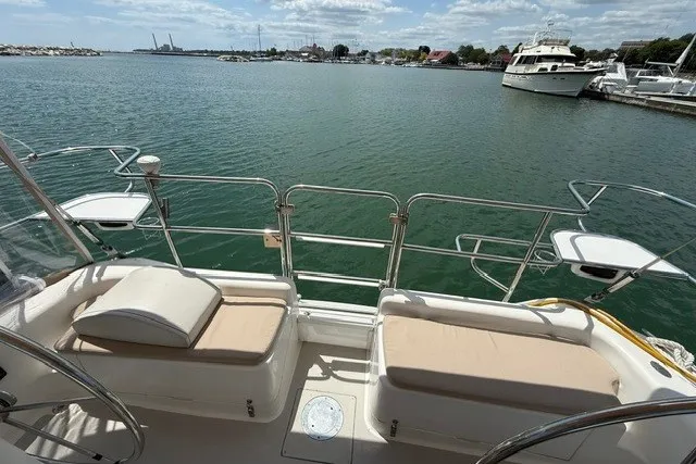 Slide: The Image of Catalina 400 sailboat deck overlooking marina, 2005 model, with cushioned seating and scenic water view. - 35