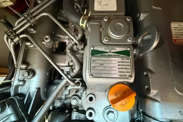 Slide: The Image of Close-up of a Catalina 400 engine, showcasing mechanical components and oil cap. - 58