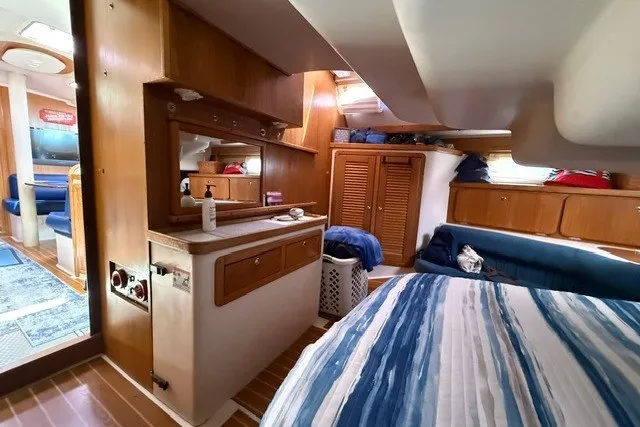 Slide: The Image of Interior of a 2005 Catalina 400 yacht with cozy cabin and wooden furnishings. - 53
