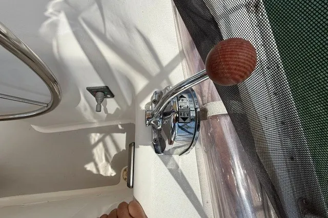 Slide: The Image of Throttle lever on a 2005 Catalina 400 sailboat cockpit, featuring a wooden handle. - 24