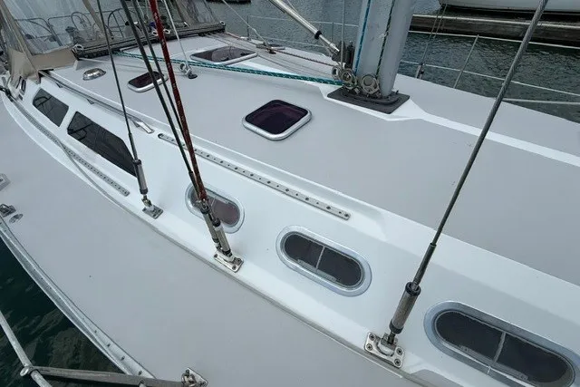 Slide: The Image of Deck view of a 2005 Catalina 400 sailboat, featuring rigging and hatches. - 9
