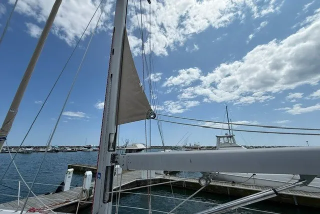 Slide: The Image of Sailboat Catalina 400 (2005) docked at marina under blue sky with clouds. - 12