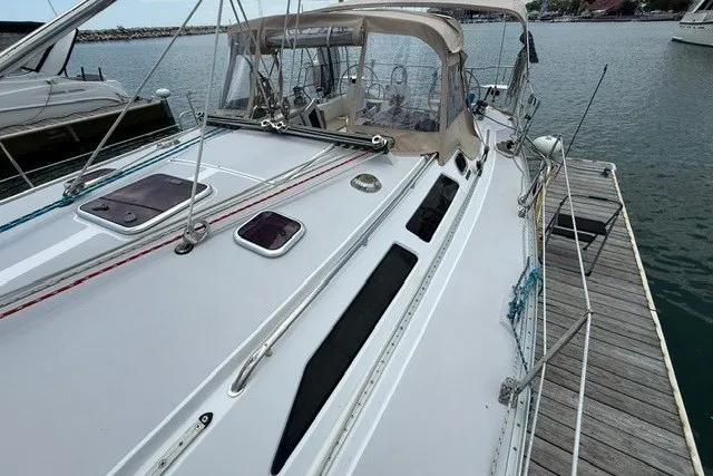 Slide: The Image of 2005 Catalina 400 sailboat docked, showcasing sleek deck design and spacious cockpit. - 14