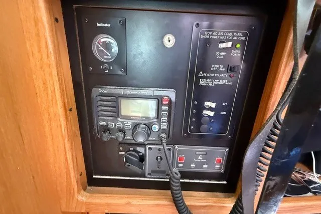 Slide: The Image of Electrical control panel on a 2005 Catalina 400 sailboat, featuring radio and power switches. - 44