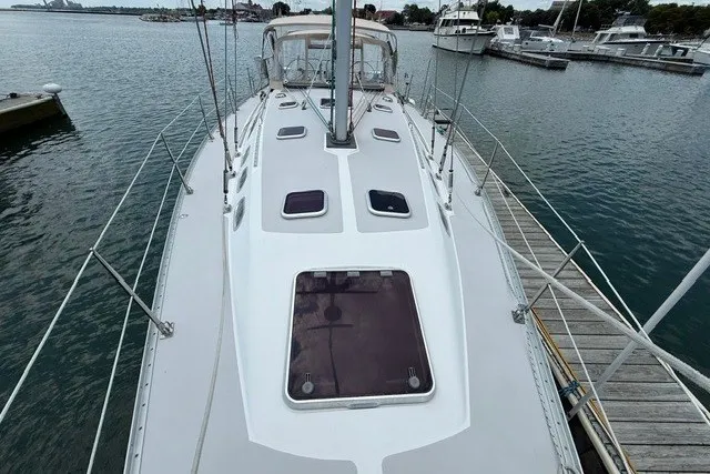 Slide: The Image of 2005 Catalina 400 sailboat docked at marina, showcasing deck and cabin features. - 8