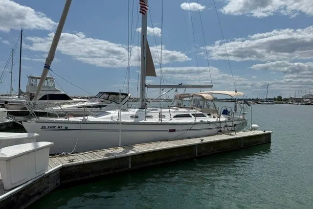 Slide: The Image of Sailboat Catalina 400, 2005 model, docked at marina under partly cloudy sky. - 4