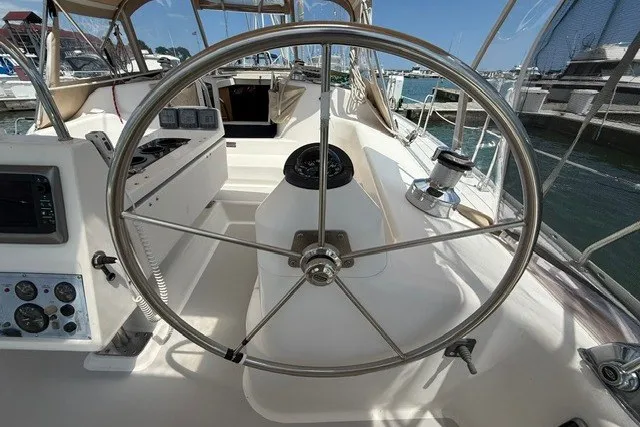 Slide: The Image of Steering wheel of a 2005 Catalina 400 sailboat in a marina setting. - 21