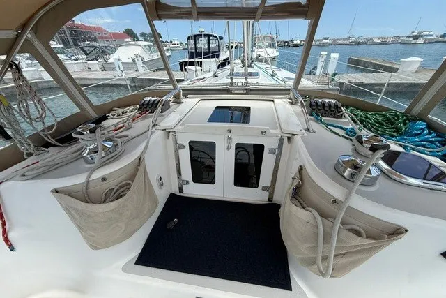 Slide: The Image of Cockpit of 2005 Catalina 400 sailboat docked at marina, featuring winches and ropes. - 17