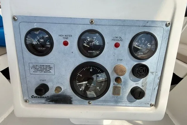 Slide: The Image of Control panel of a 2005 Catalina 400 boat with gauges and switches. - 27