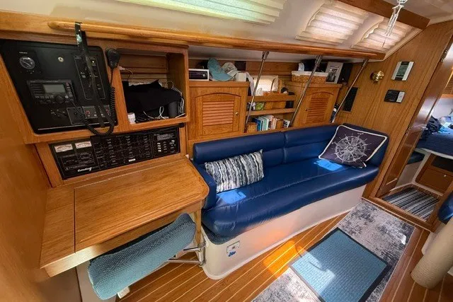 Slide: The Image of Interior of a 2005 Catalina 400 yacht with blue seating and wooden cabinetry. - 42