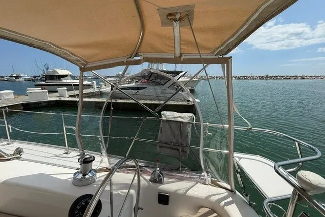 Slide: The Image of Cockpit view of a 2005 Catalina 400 sailboat docked at a marina. - 36