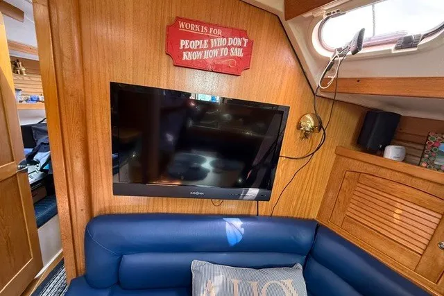 Slide: The Image of Interior of a 2005 Catalina 400 yacht with TV and blue seating. - 46