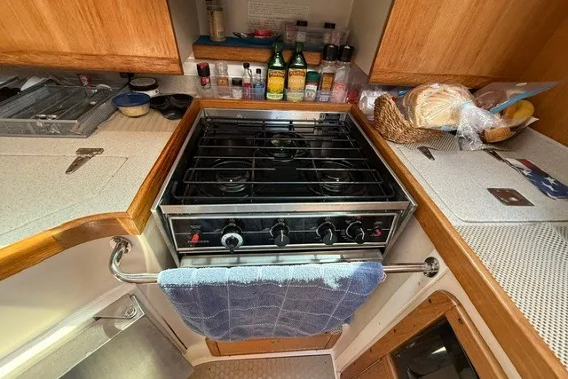 Slide: The Image of Compact kitchen in a 2005 Catalina 400 sailboat with stove, spices, and bread. - 40