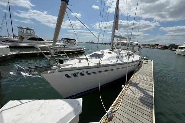 Slide: The Image of Catalina 400 sailboat docked at marina, 2005 model, under partly cloudy sky. - 2