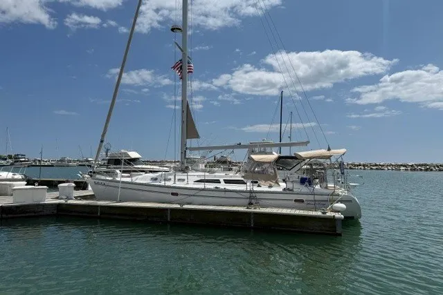 Slide: The Image of Sailboat Catalina 400 (2005) docked in a sunny marina with blue skies. - 5