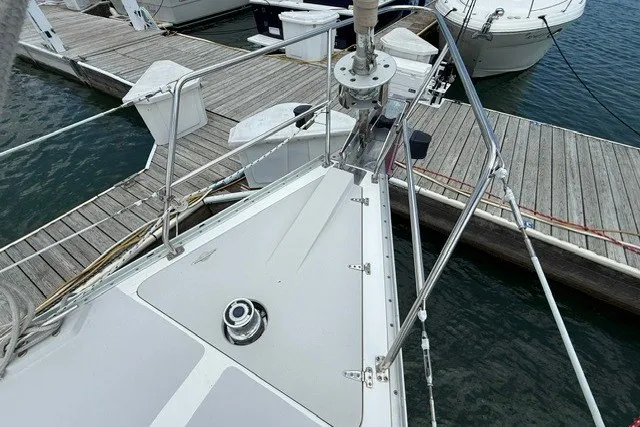 Slide: The Image of 2005 Catalina 400 sailboat docked at marina, showing bow and deck details. - 6