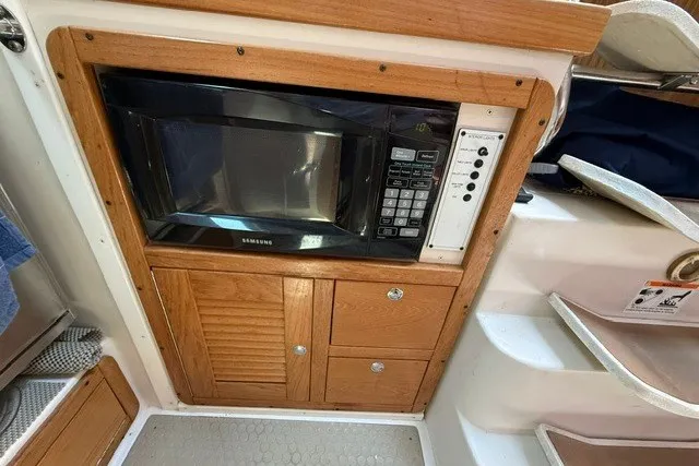 Slide: The Image of Built-in microwave in 2005 Catalina 400 yacht kitchen with wooden cabinetry. - 39