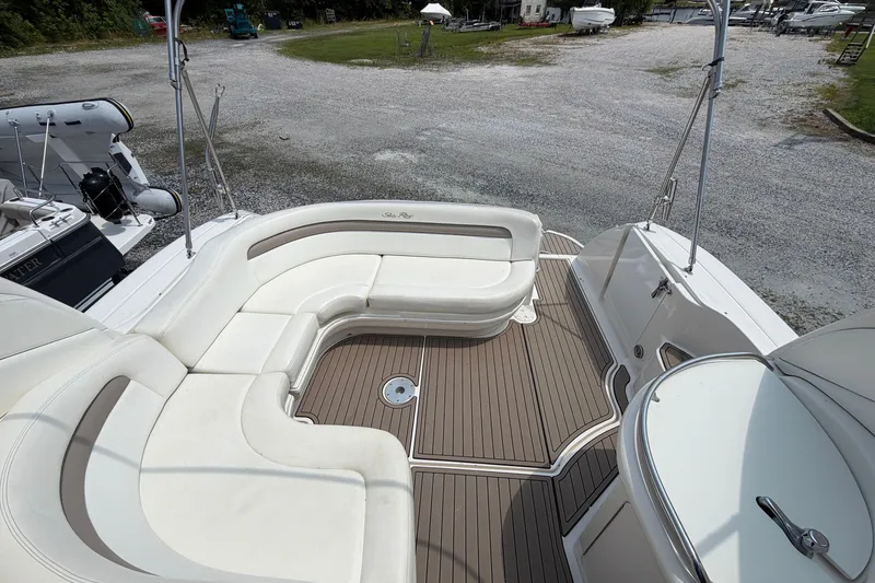 Slide: The Image of 2005 Sea Ray 340 Sundancer boat deck with white seating and wood flooring. - 20