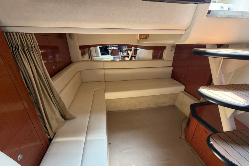 Slide: The Image of Interior of 2005 Sea Ray 340 Sundancer yacht with beige seating and wooden accents. - 15