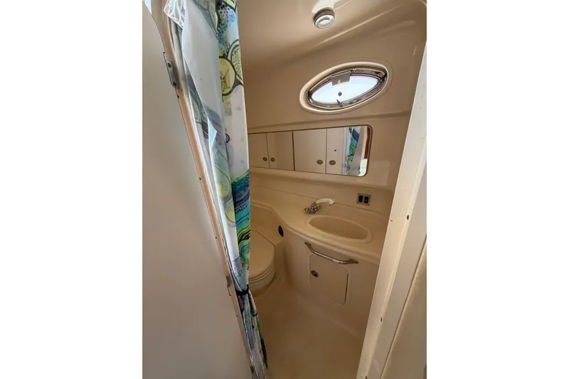 Slide: The Image of 2005 Sea Ray 340 Sundancer bathroom with sink, mirror, and shower curtain. - 11