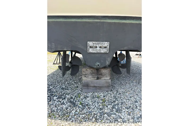 Slide: The Image of Rear view of 2005 Sea Ray 340 Sundancer boat propellers on gravel. - 21